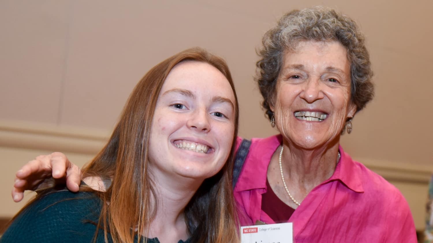 Donor Aimee Tattersall smiles with a student