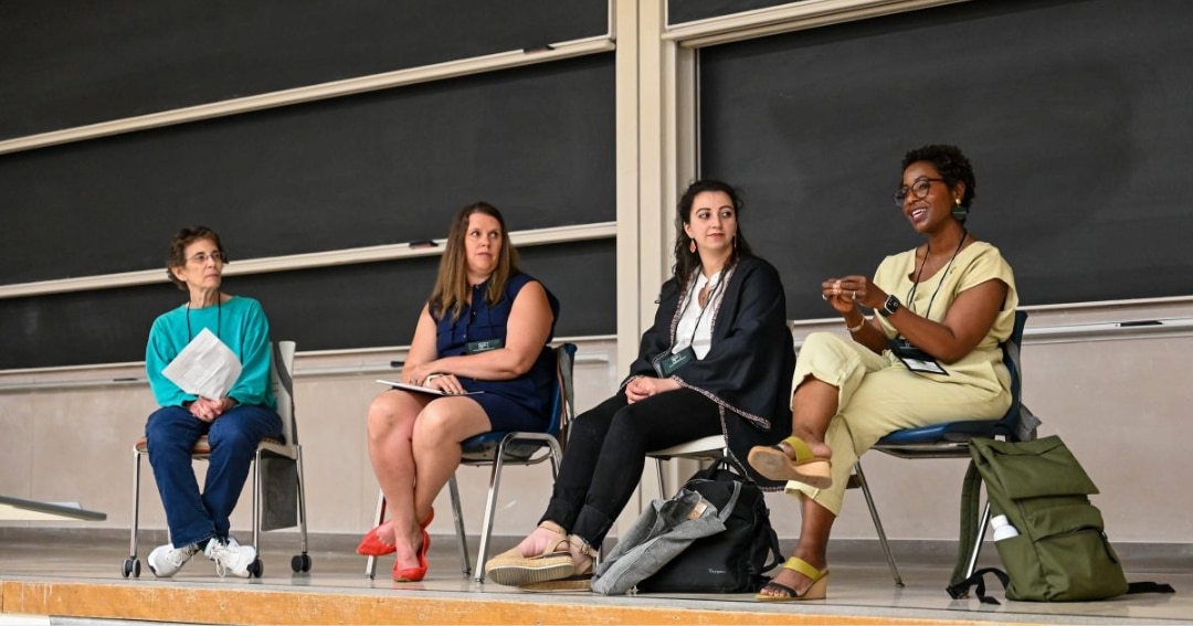 4 women sitting in chairs for a panel discussion